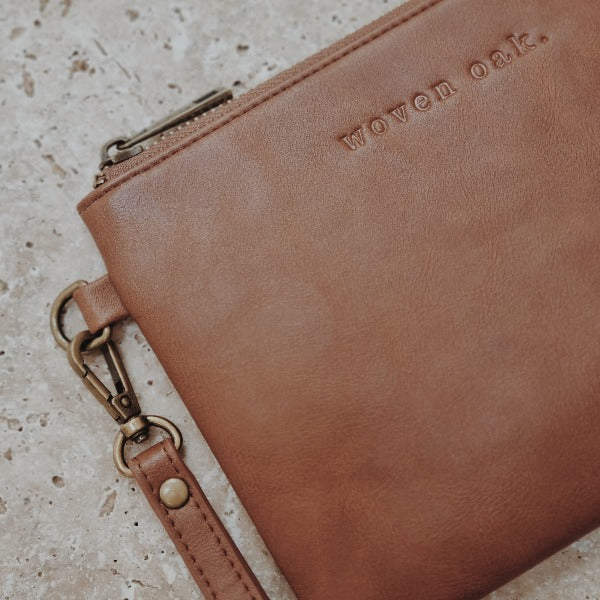 CLOSE UP OF BROWN VEGAN LEATHER CLUTCH